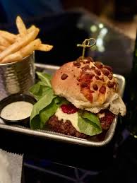 Norton’s Brewing Company signature dishes The Mother Clucker (fried chicken sandwich), Totchos (tater tot nachos), specialty burgers, rotating experimental dishes